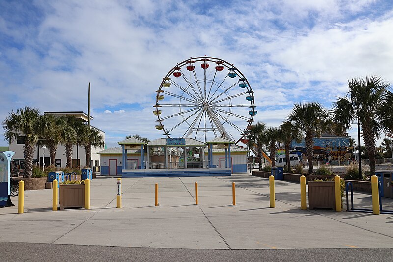 Carolina Beach Boardwalk view showing shops and neon signs
