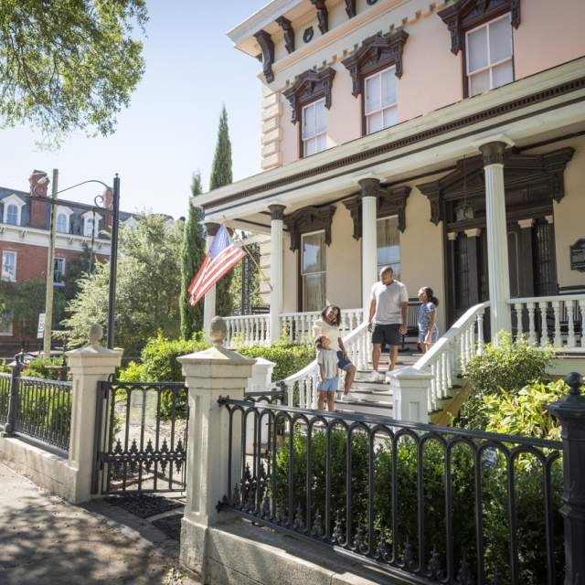 Family on the porch of a historic home in downtown Wilmington NC