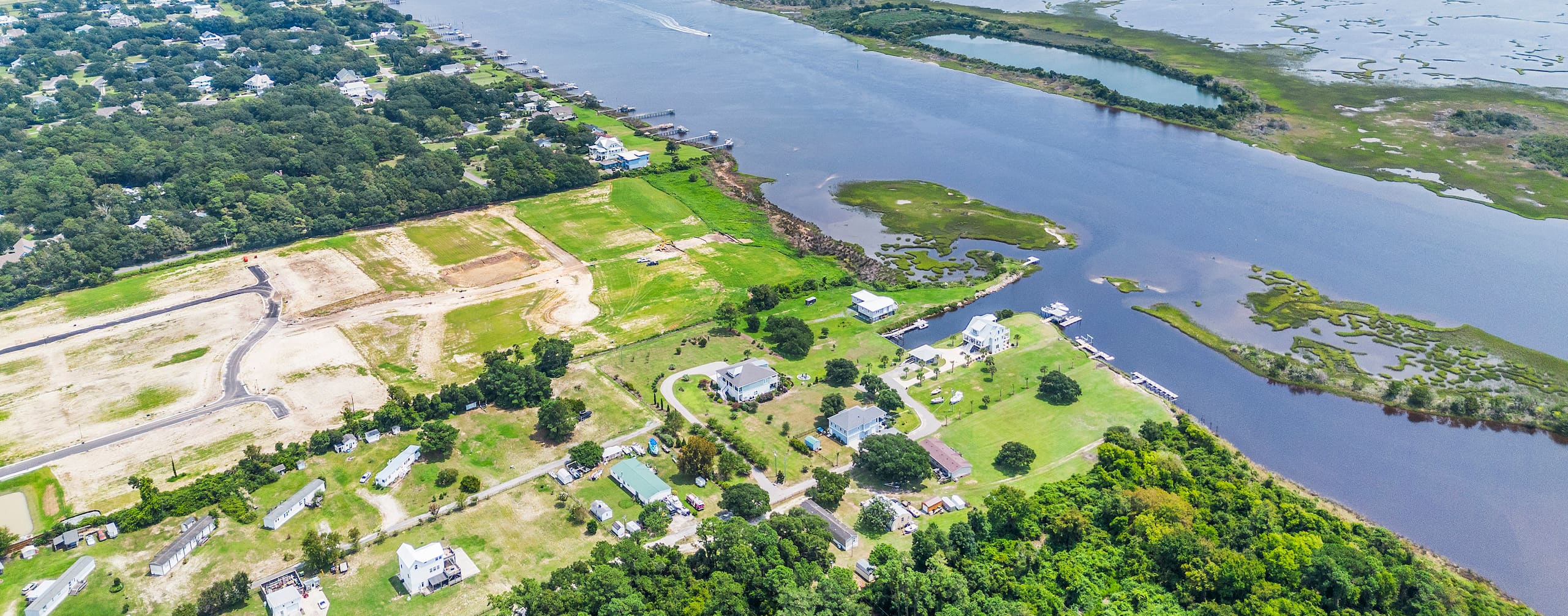 Aerial view over Hampstead, North Carolina, looking across new residential lots being graded toward the Intracoastal Waterway and the marshes behind Topsail Island