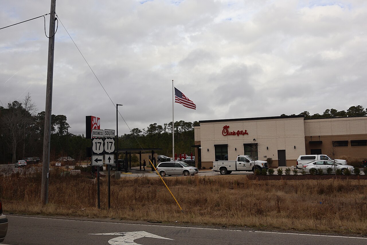 US 17 Business and US 17 route signs beside a Chick-fil-A on the highway commercial corridor in Shallotte, North Carolina