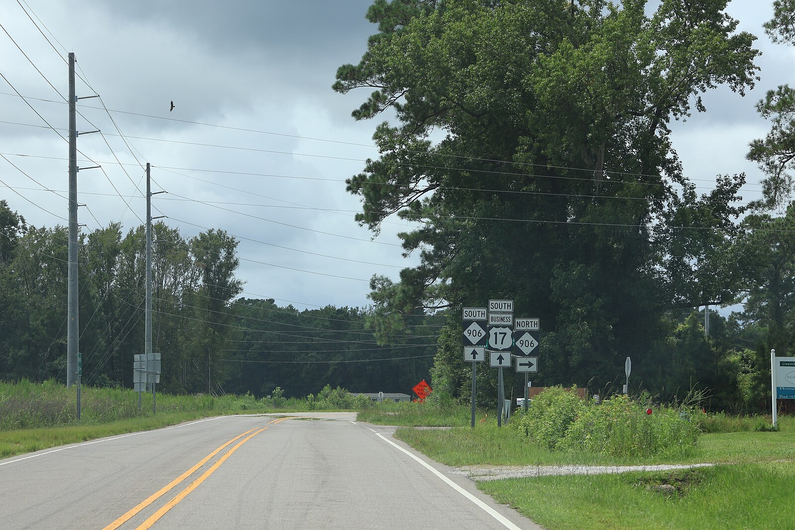 US 17 Business South and NC 906 route signs on a two-lane road in Bolivia, Brunswick County, North Carolina