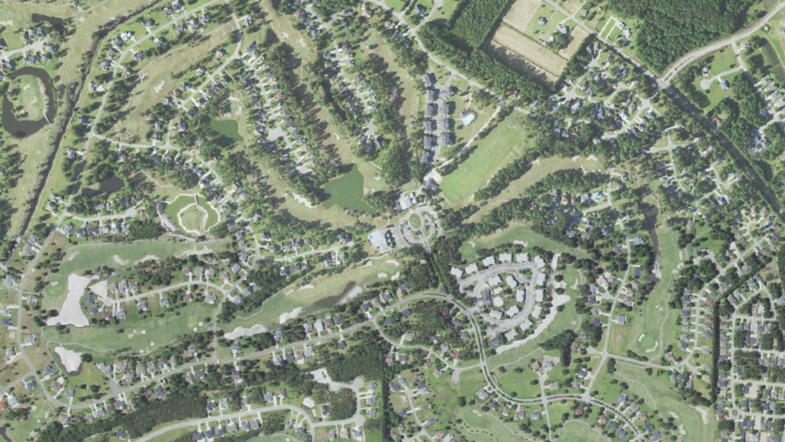 Aerial view of fairways, lakes, villa clusters and homes along the golf course at the center of Brunswick Plantation near Brunswick Drive NW in Calabash, Brunswick County, North Carolina