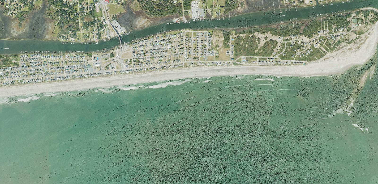 Aerial view of the east end of Holden Beach, North Carolina, showing the single bridge over the Intracoastal Waterway and the shoals at Lockwood Folly Inlet