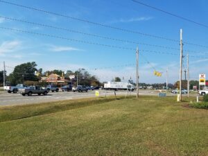 The central junction of Murrayville, North Carolina, where Murrayville Road meets North College Road, with a pharmacy, a gas station and the Murrayville street sign in view