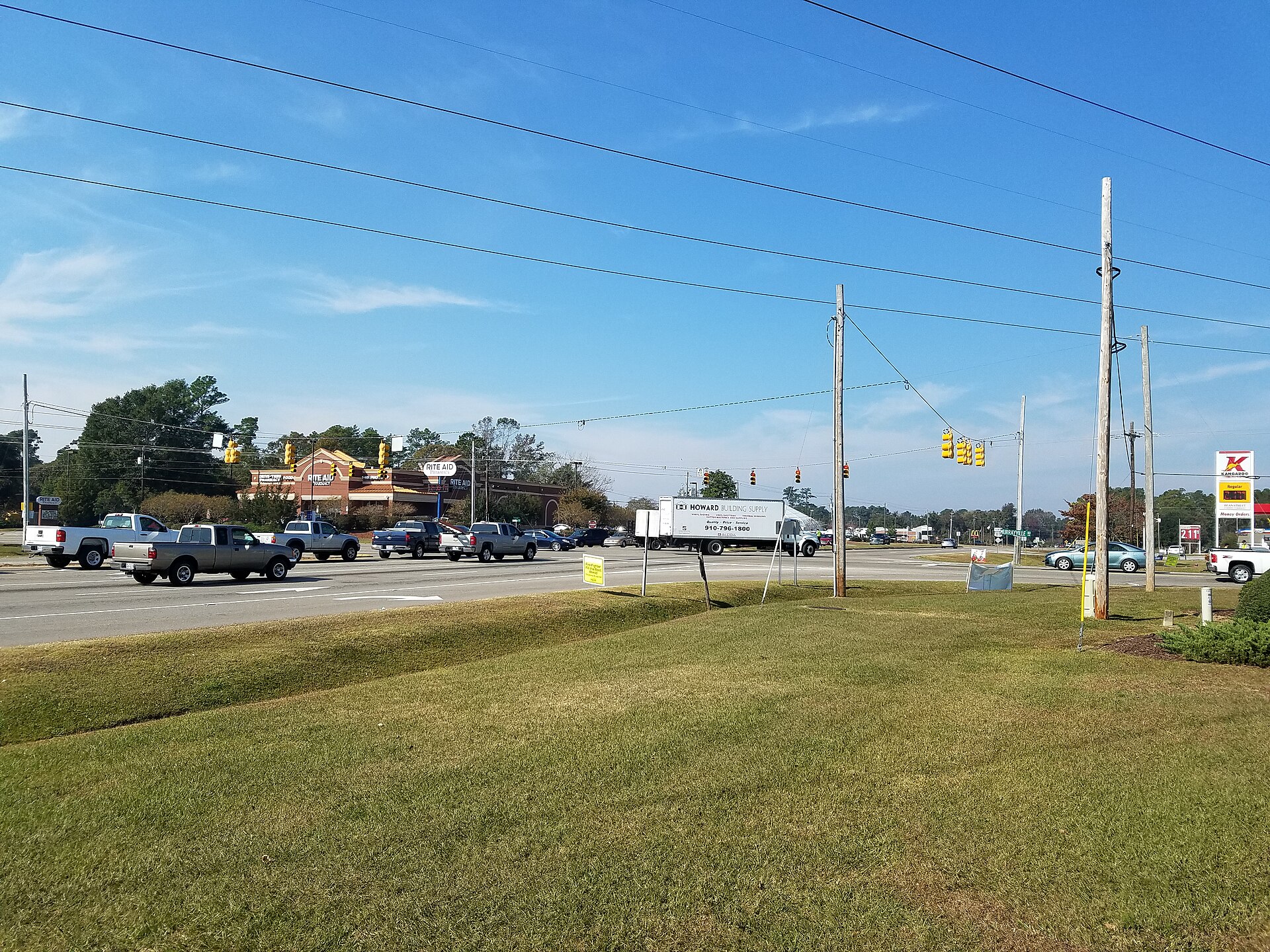 The central junction of Murrayville, North Carolina, where Murrayville Road meets North College Road, with a pharmacy, a gas station and the Murrayville street sign in view