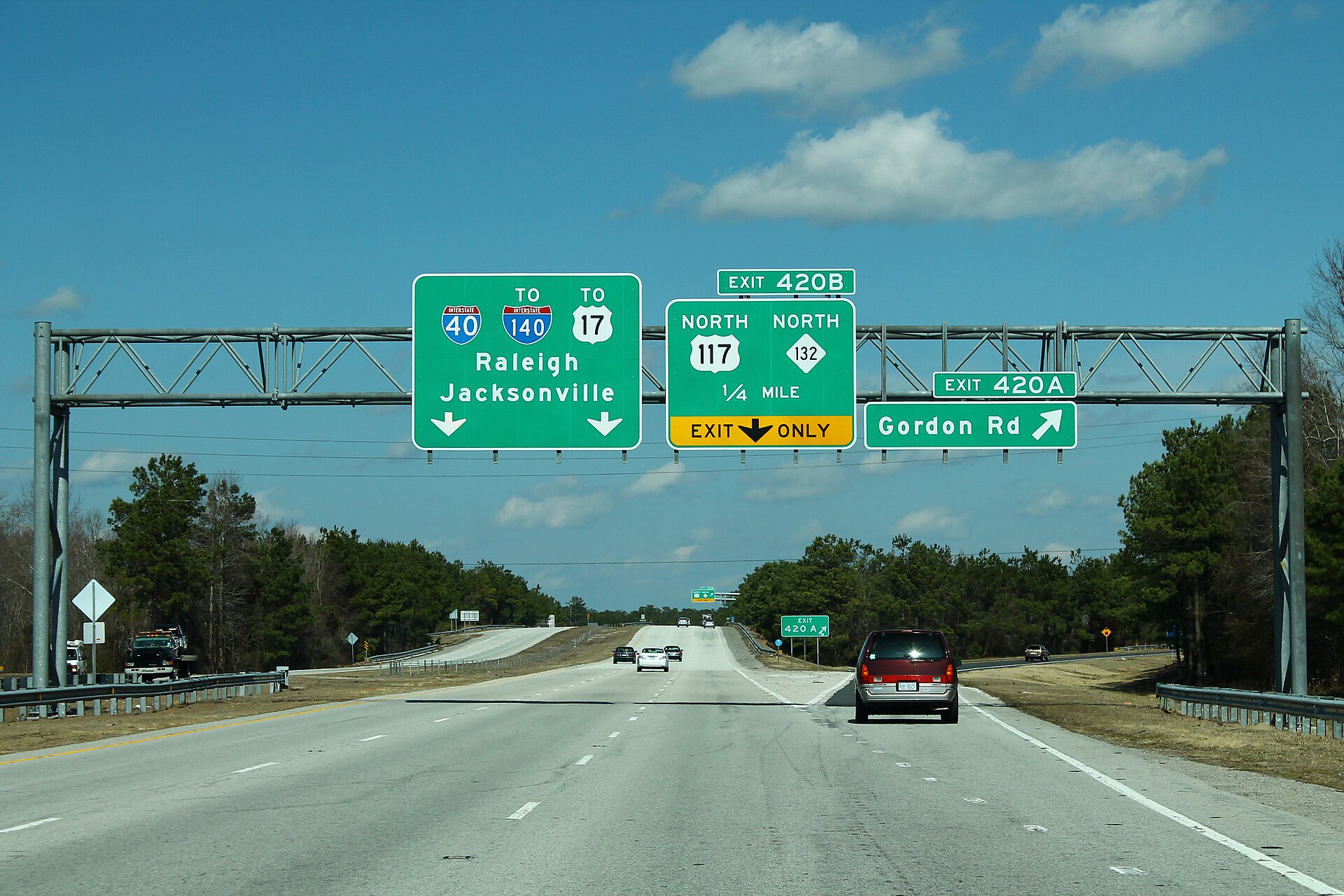 Interstate 40 westbound approaching Exit 420A for Gordon Road and Exit 420B for US 117 and NC 132 north in New Hanover County, North Carolina