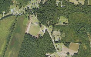 Aerial view of homes, a ball field and pine timber along Vernon Road in Northwest, Brunswick County, North Carolina