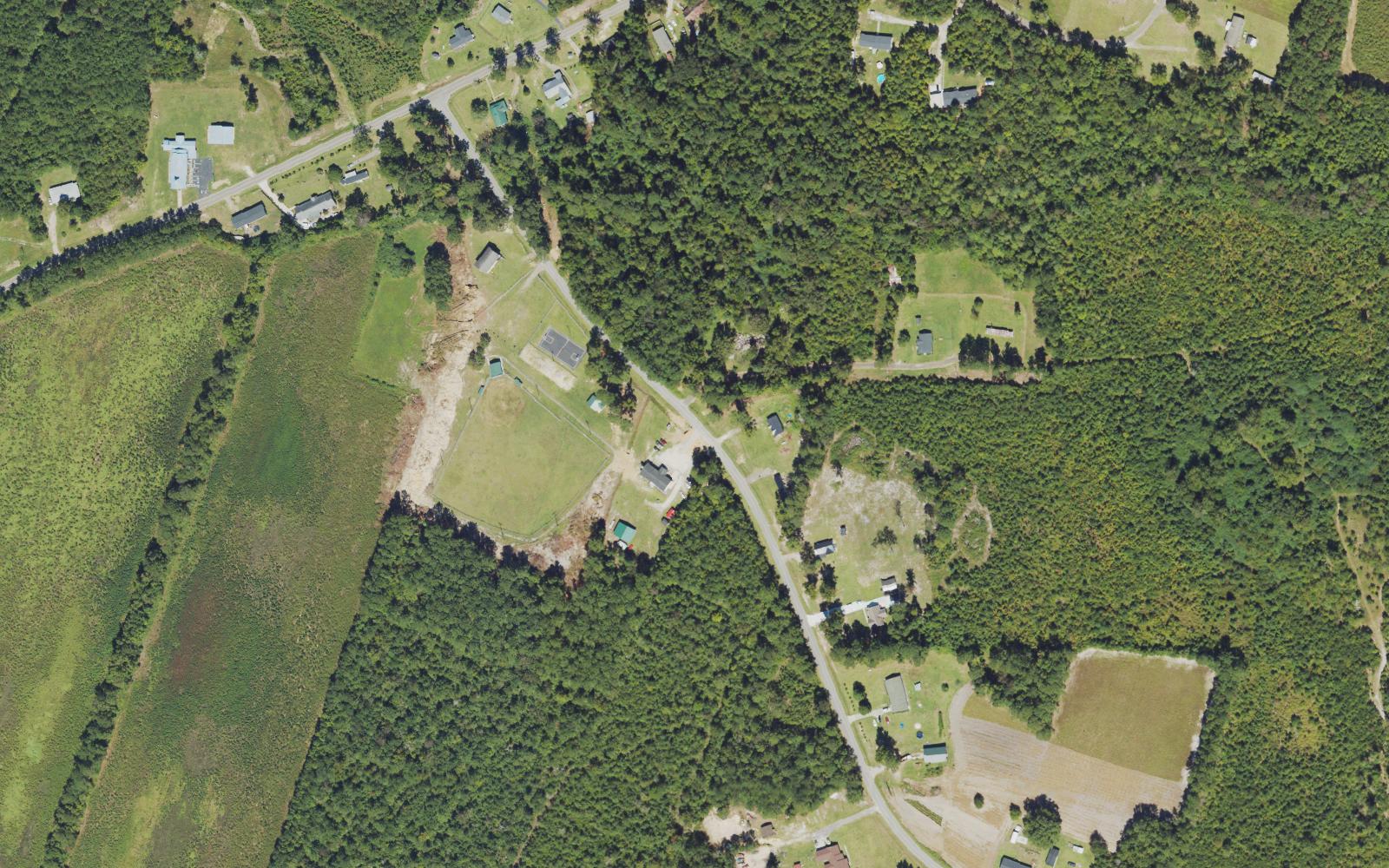 Aerial view of homes, a ball field and pine timber along Vernon Road in Northwest, Brunswick County, North Carolina
