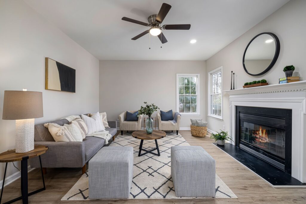 A staged living room with neutral furniture, the kind of presentation sellers weigh before listing