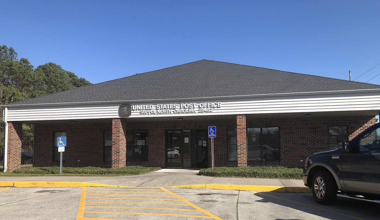 The United States Post Office building and parking lot in Supply, North Carolina