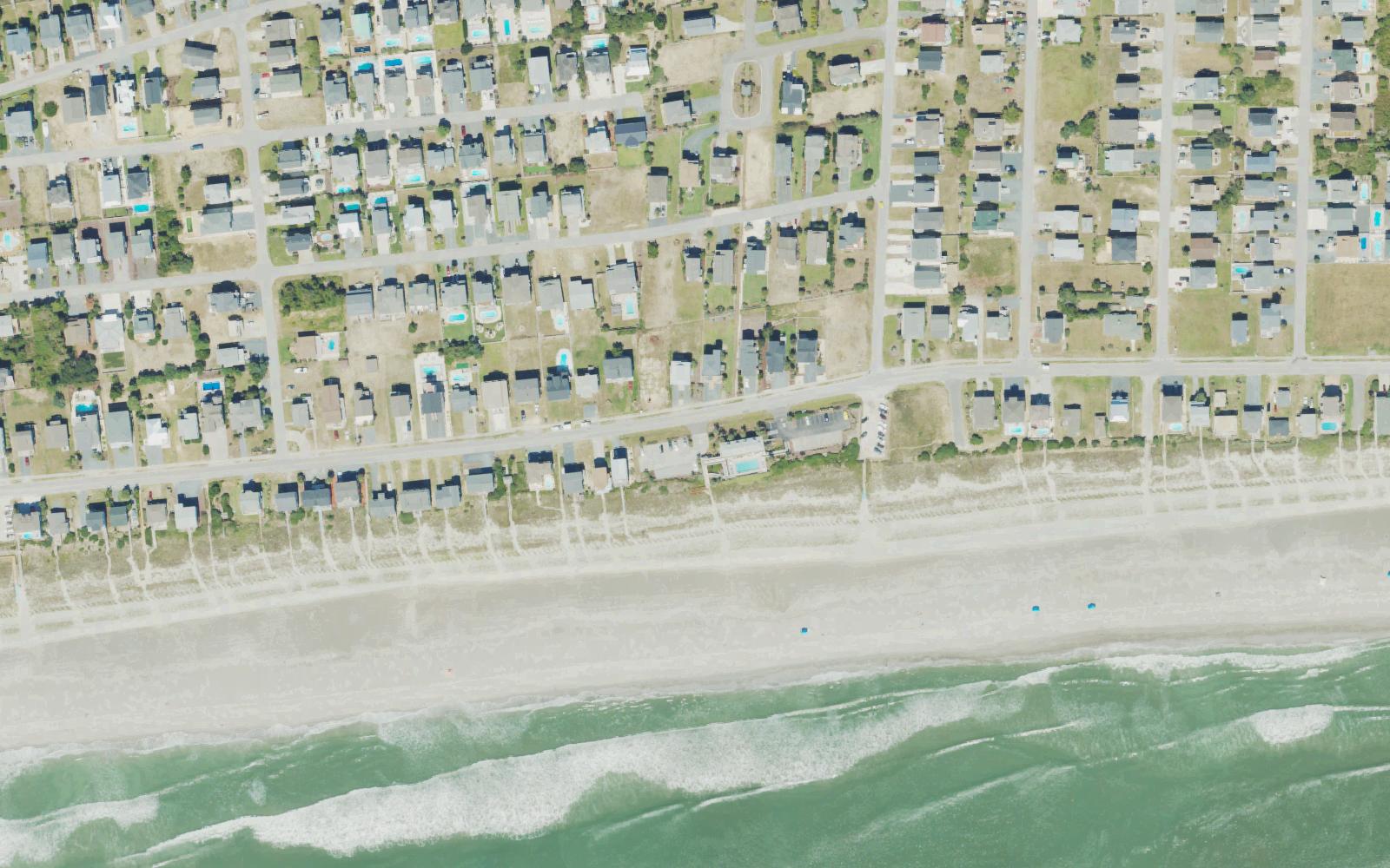 Aerial view of the oceanfront at Holden Beach, North Carolina, along Ocean Boulevard East, where Winding River Plantation owners have a private gated beach house with a pool