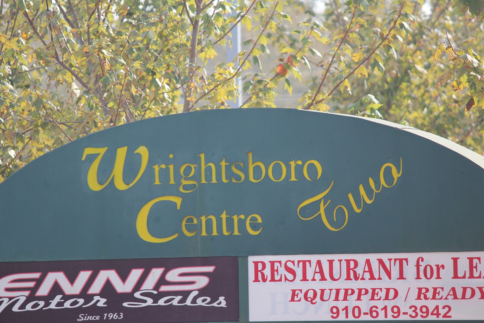 The Wrightsboro Centre Two sign on Castle Hayne Road in Wrightsboro, North Carolina, listing Ennis Motor Sales and a restaurant space for lease